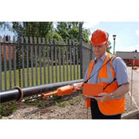 The Rolling Spring Electrode in Use on a 150 mm Diameter Pipe The High Voltage Handle is fitted with an Insulated Second Handle to Aid Handling